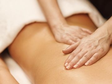 Woman getting Swedish massage deep tissue and relaxation therapy