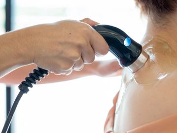 Ultrasound wand being applied to patient's  back and neck