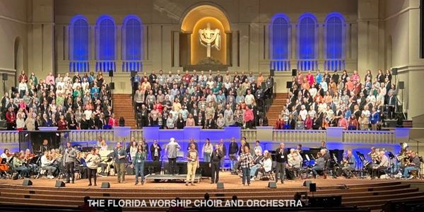 The Florida Worship Choir and Orchestra perform in a grand church setting.