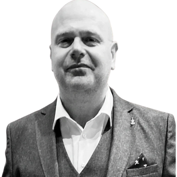 A bald man in a suit with a pocket square.