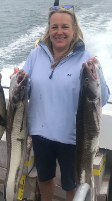 a lady customer with two ling she has caught in falmouth onboard seawatch