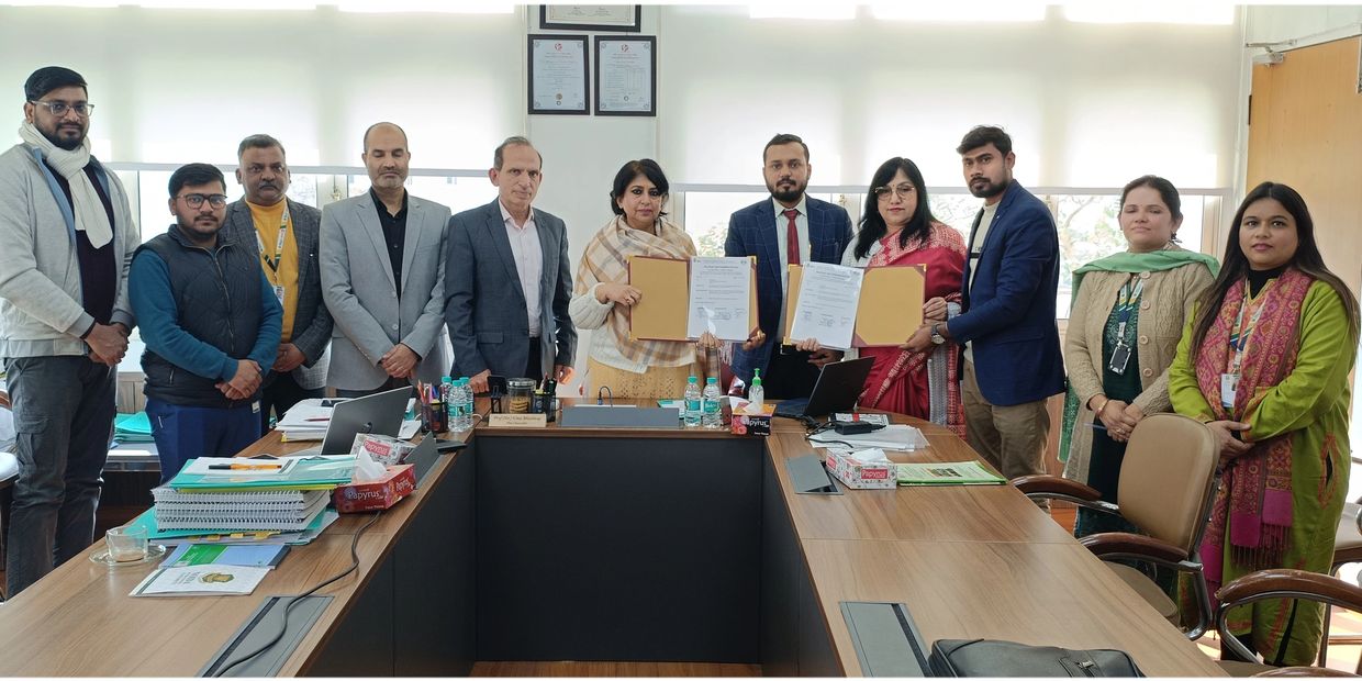 Group of professionals in a meeting room holding signed documents.
