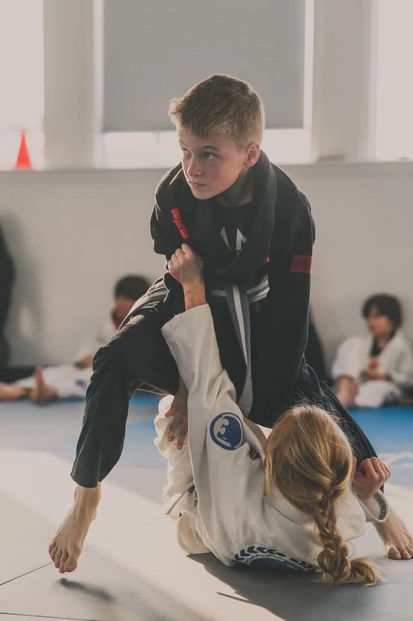 Our younger students live rolling in the Gi after Kids Evening Gi Class