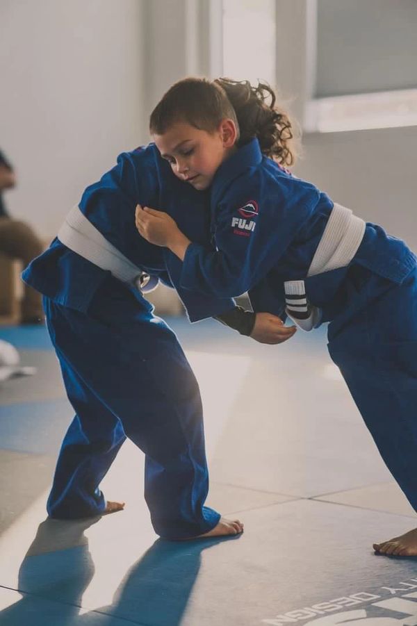 Two of our students live rolling in the Gi during our Kids Evening BJJ Gi Class. 