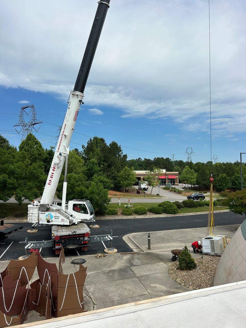 stick boom crane lifting HVAC unit