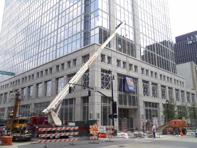crane lifting banner for commercial business in Raleigh
