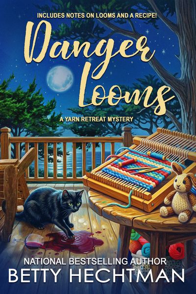 A black cat on a porch with yarn and a stuffed bunny under a moonlit sky.