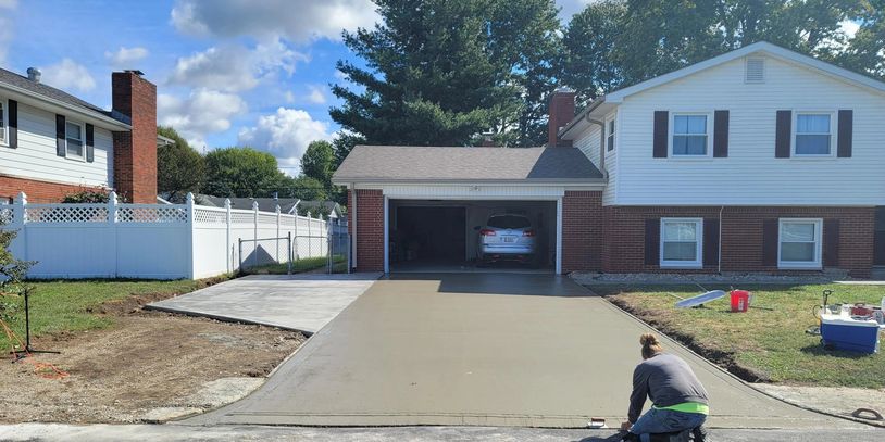 Cutting in the front edge of this concrete driveway installed by First Impression Driveways.
