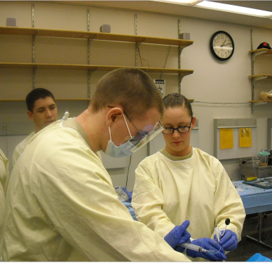 Medical students in a lab performing a procedure.