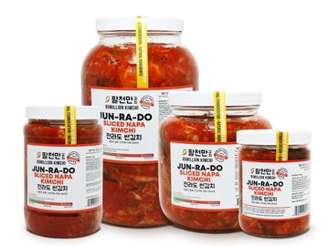 Various jars of Jun-Ra-Do sliced napa kimchi in different sizes.