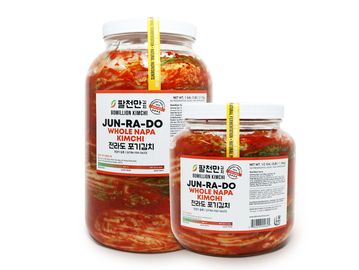 Two jars of Jun-Ra-Do Whole Napa Kimchi with white lids and Korean labels.