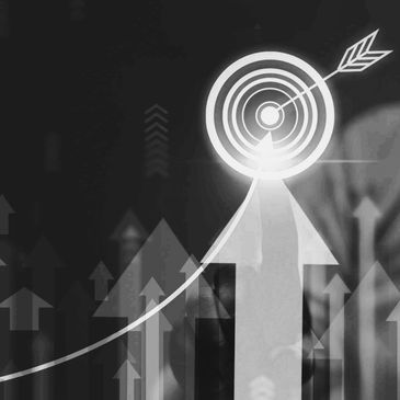Hand pointing at a glowing target with upward arrows symbolizing growth and success.
