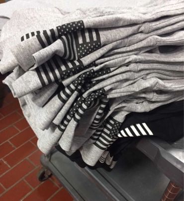 A pile of grey shirts