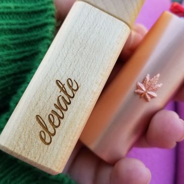 Elevate stashbox and lighter being held by shirley bong.