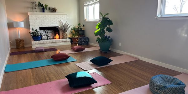 Sunlit room with 6 yoga mats and pillows.