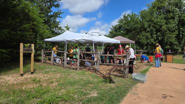 NTAS volunteers and children attending the archaeology camp work with various archaeology tools.