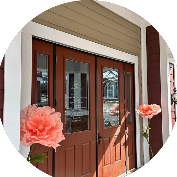 Front door entrance of Renew Wellness spa with large flowers.