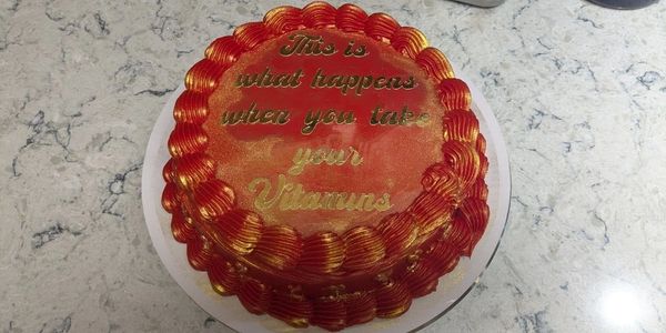 8" Custom gluten free cake order with red frosting, custom topper, and luster dust. DFW Baker