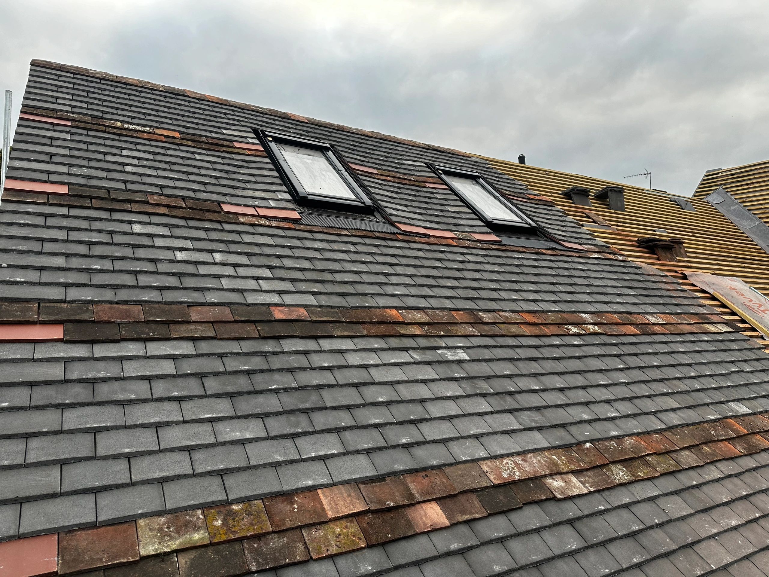 Tiled pitch roof installation in progress