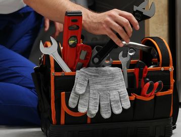 Handyman performing routine home maintenance during a scheduled tune-up service.