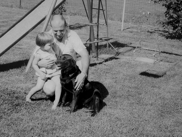 Black and white photo of a father and child at a park