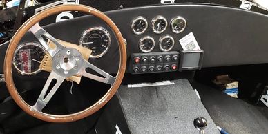 Part of a restomod on a classic Cobra with new gauges and pushbuttons.