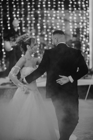 Bride and groom sharing a joyful dance at their wedding.