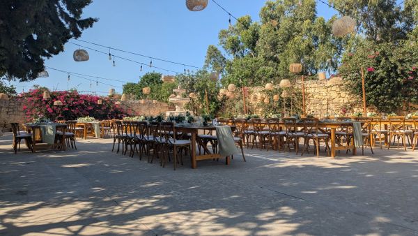A rustic dinner setup in an outdoor courtyard