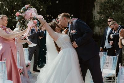 Bride and groom share a joyful kiss during wedding celebration.