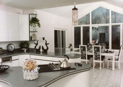 Black and white Laminate kitchen with curves, radius doors and 2 inch inlay solid surface countertop