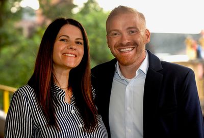 Smiling man and woman posing outdoors.