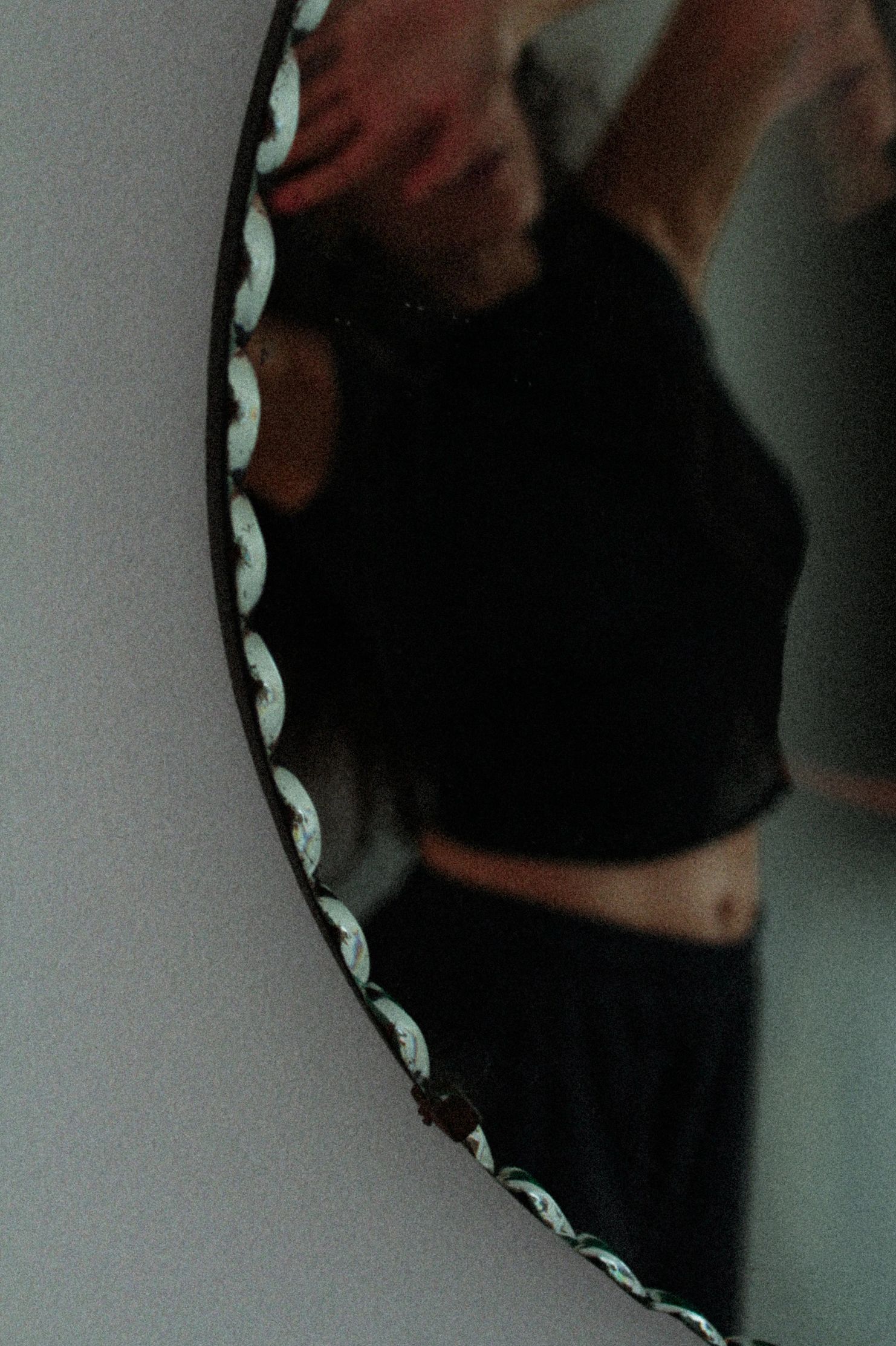 Person taking a mirror selfie in a black outfit.
