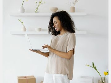 Woman standing with a laptop
