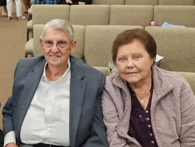 Elderly couple sitting together on a couch.