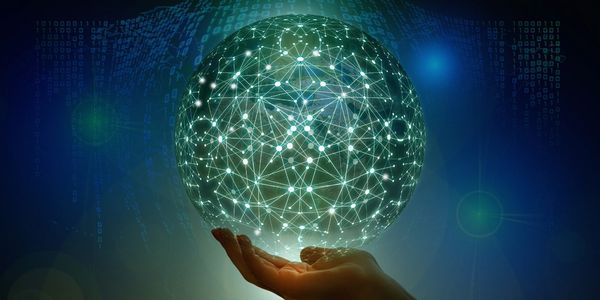 Hand holding a glowing digital network sphere representing technology and connectivity.