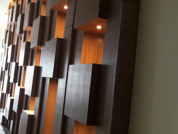 Modern wooden wall with illuminated cavities.