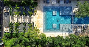 Aerial view of AWA Playacar’s resort pools and lush tropical gardens in Playa del Carmen, showcasing