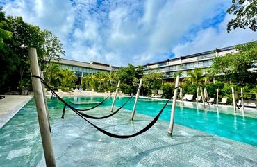 Unique hammock pool at AWA Playacar, combining tropical relaxation and resort-style amenities in Pla