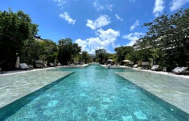 Modern lap-style swimming pool with crystal-clear water at AWA Playacar, ideal for relaxation and en