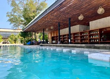 Poolside bar and seating area overlooking the swimming pool at AWA Playacar, perfect for relaxing in