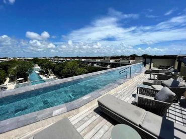 Elegant spa-style swimming pool with wide entry steps at AWA Playacar, designed for comfort and rela