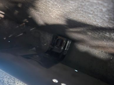 Close-up of a car seatbelt buckle inside a vehicle.