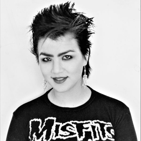 Young person with spiky hair and Misfits shirt.