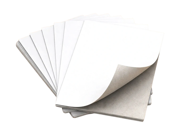A stack of blank white papers fanned out with one page slightly curled.