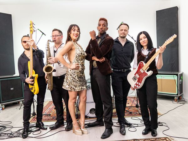 A stylish band posing with their instruments.