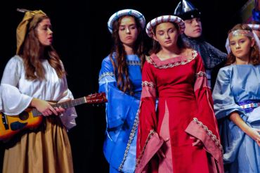 Group in medieval costumes during a play.