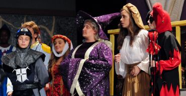 Group in medieval costumes on stage.