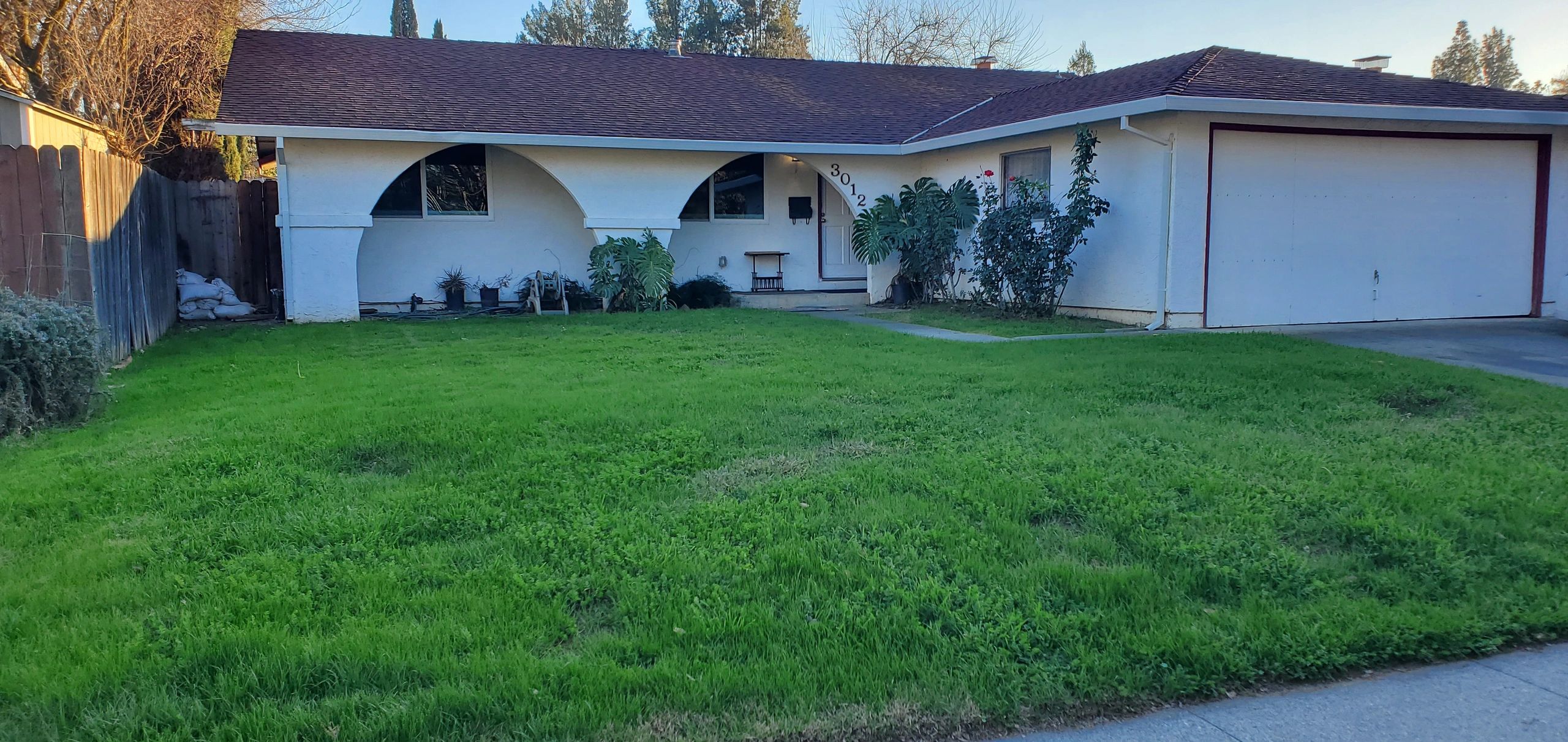 Single-story house with a green lawn and garage.