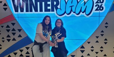 Two girls holding a trophy at Winter Jam 2026 event.