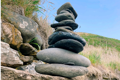 a stack of stones on the side of a hill